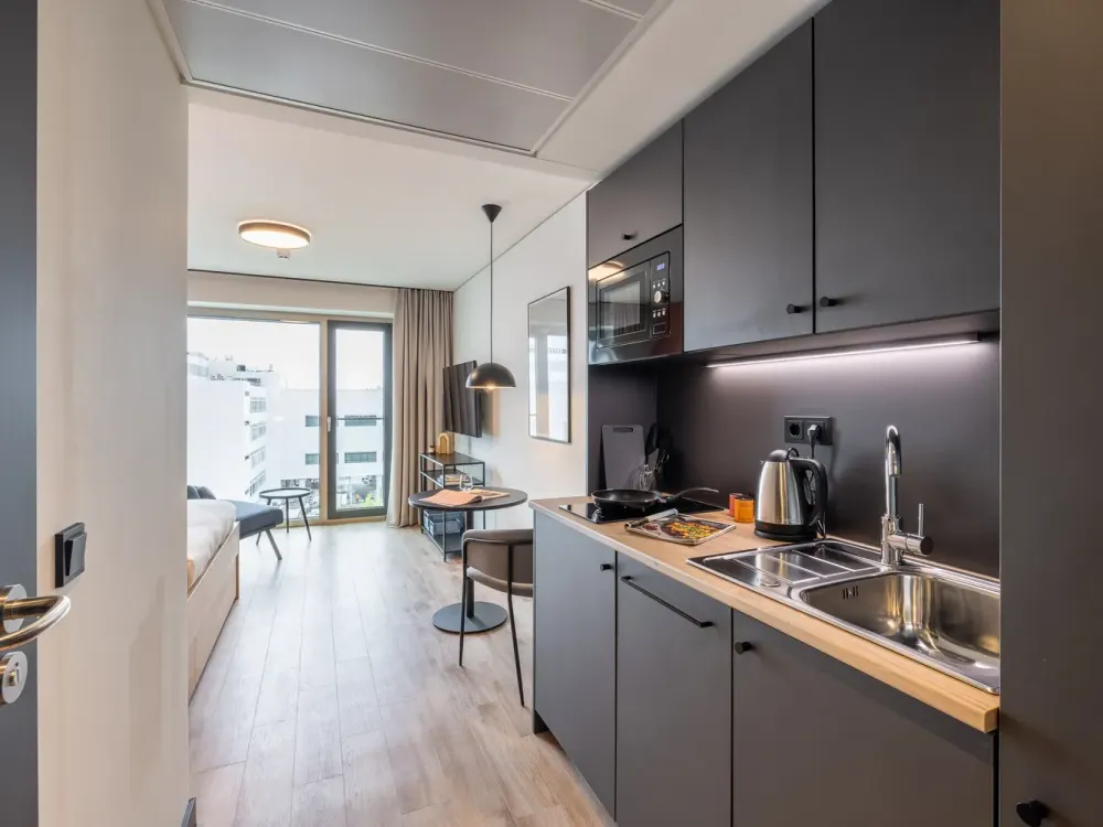 Furnished micro apartments, community areas, coworking & gym close to BMW