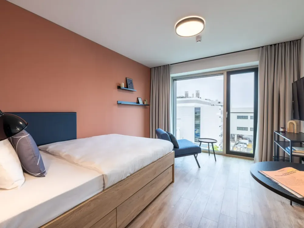 Furnished micro apartments, community areas, coworking & gym close to BMW