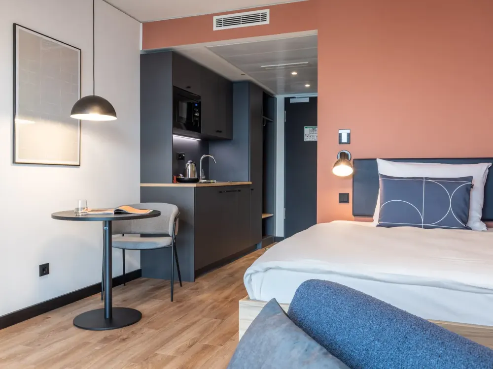 Furnished micro apartments, community areas, coworking & gym close to BMW
