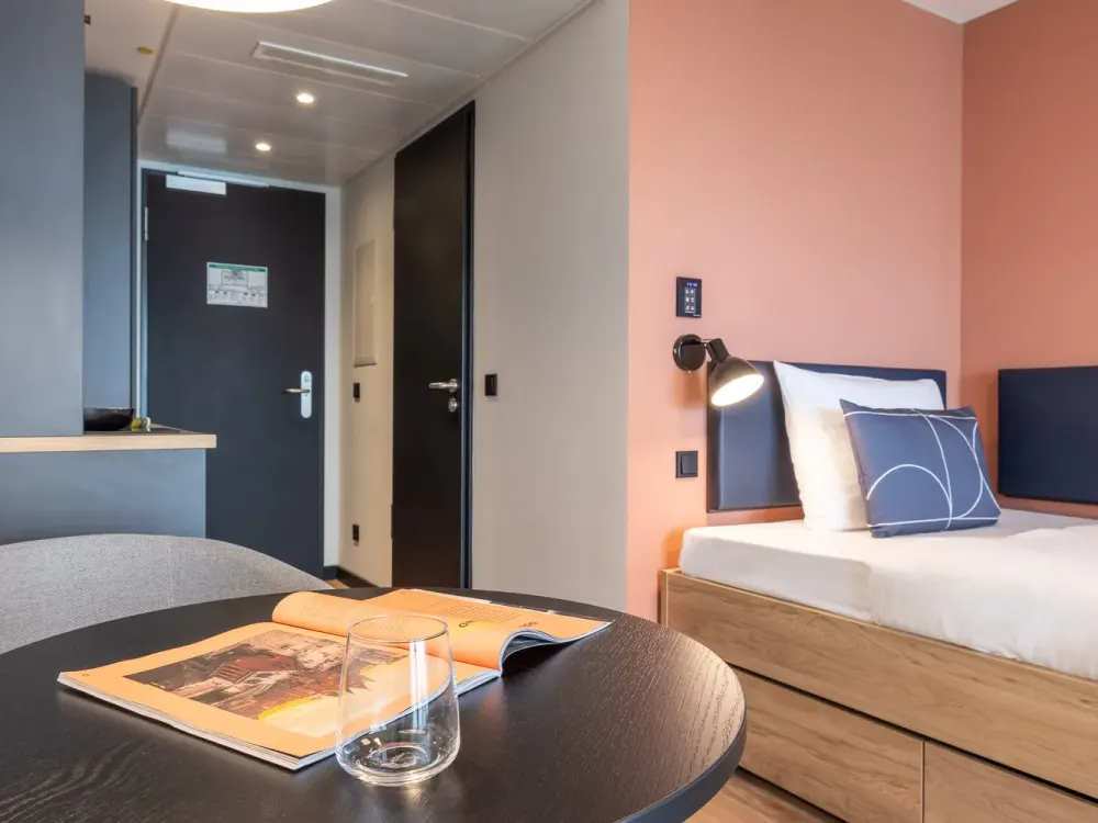 Furnished micro apartments, community areas, coworking & gym close to BMW