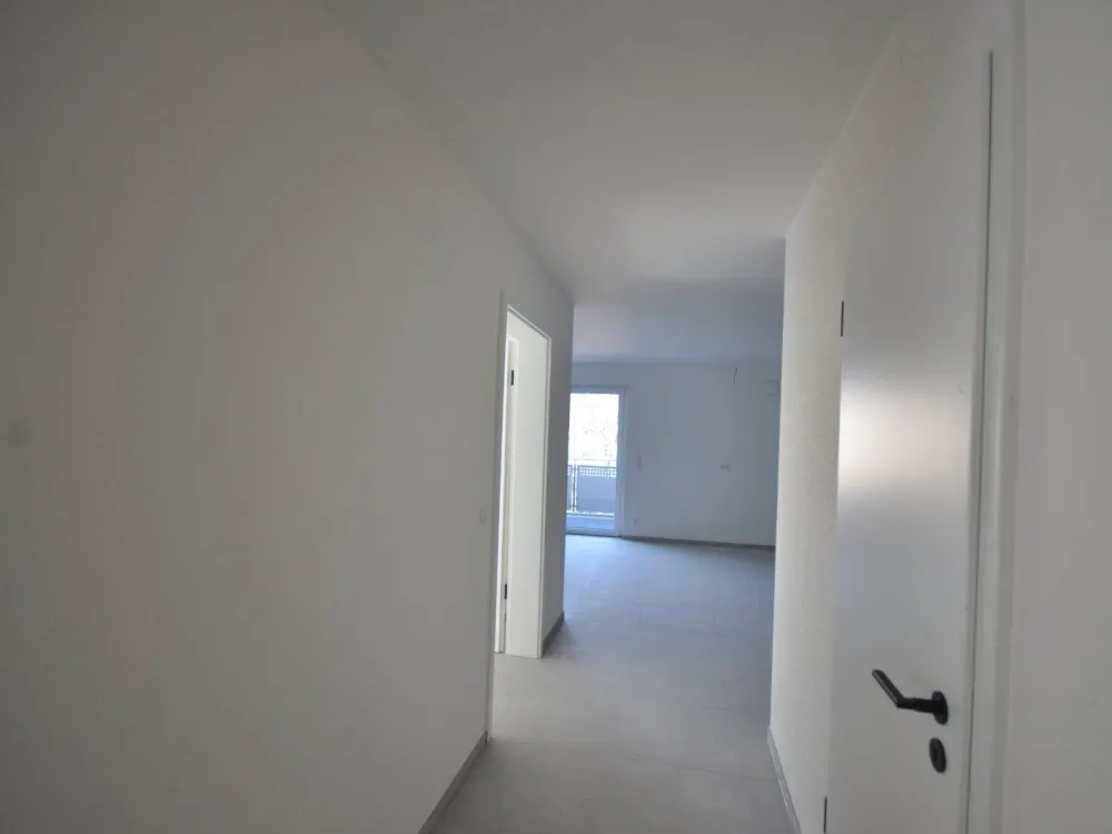 Modern 3-room new-build apartment with balcony, fitted kitchen and underground parking space, directly at the university