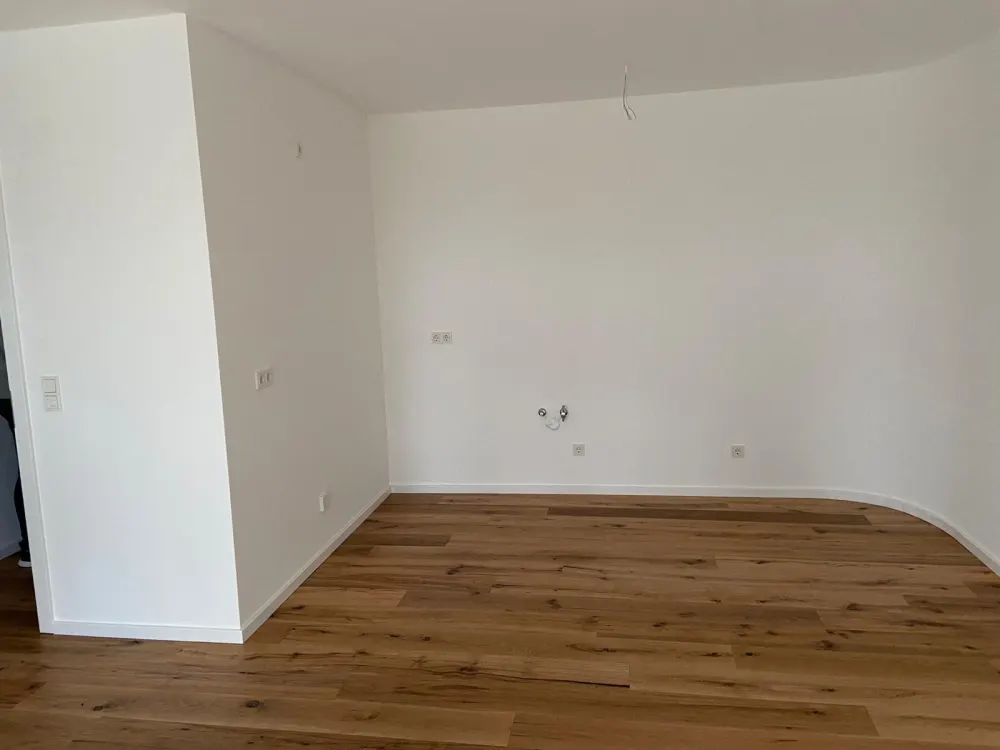 First-class 2-room new-build apartment with garden and underground parking space