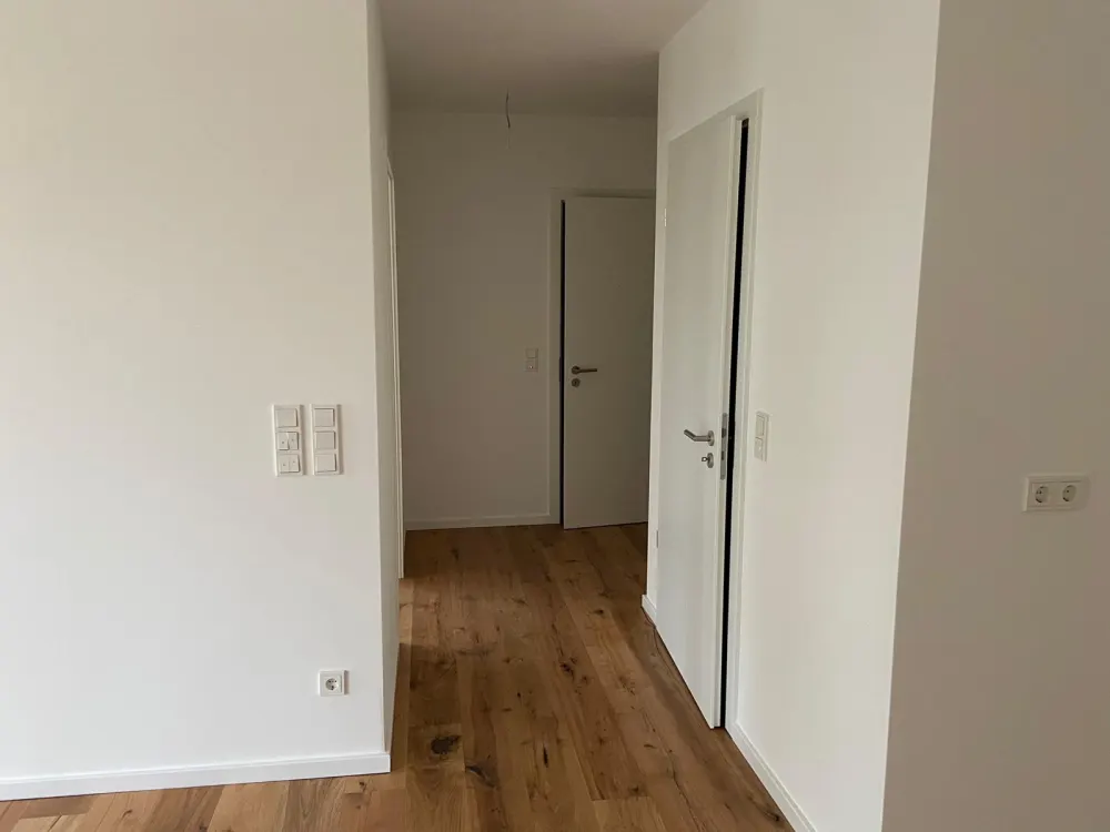 First-class 2-room new-build apartment with garden and underground parking space