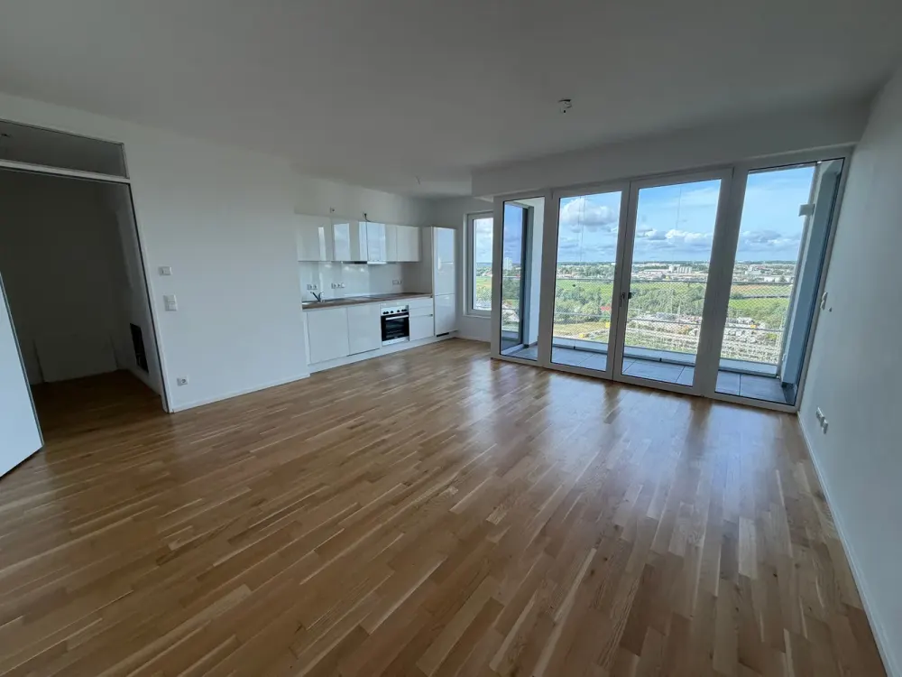 Living in new-build standard with fitted kitchen, underground parking and distant view!